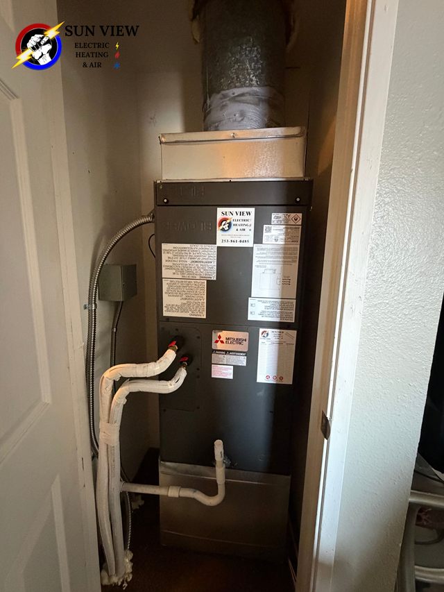 An installed air handler standing next to a water heater
