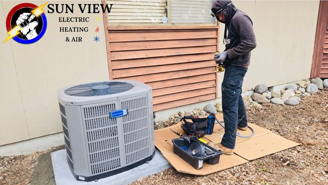 A technician setting a condenser down on its pad