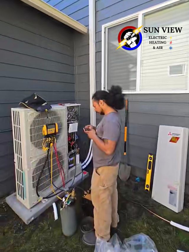 A technician checking a heat pump condenser with a set of refrigeration gauges