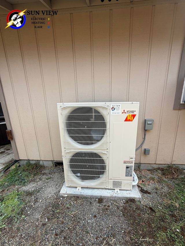 A single Mitsubishi heat pump condenser installed outside a house